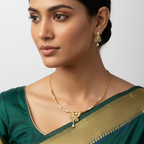 Gold necklace and earrings set with leaf-inspired white-stone pendant, worn on model with matching drop earring