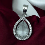Silver teardrop pendant necklace with clear crystal halo, worn on model with saree