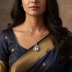 Silver teardrop pendant necklace with clear crystal halo, worn on model with saree