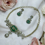 Antique gold green stone Kundan necklace set with teardrop pendant and matching earrings, flat-lay detail shot