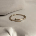 Carina nail-motif cuff bracelet worn on a wet wrist by a pool