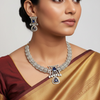 Gold-finish necklace set with blue sapphire-inspired drop and polki-style crystals, flat-lay on cushion