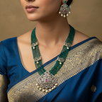 Antique gold green beaded necklace set with pearl statement pendant, worn on model with matching drop earrings