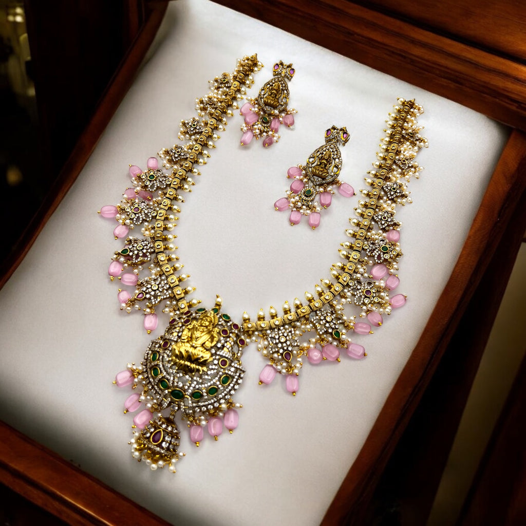 Gold-plated Lakshmi temple necklace set with pink beads, pearls and CZ stones, flat-lay of full necklace and earrings