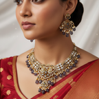 Antique gold necklace set with white stones, pearls and grey drop beads, worn on model with red saree
