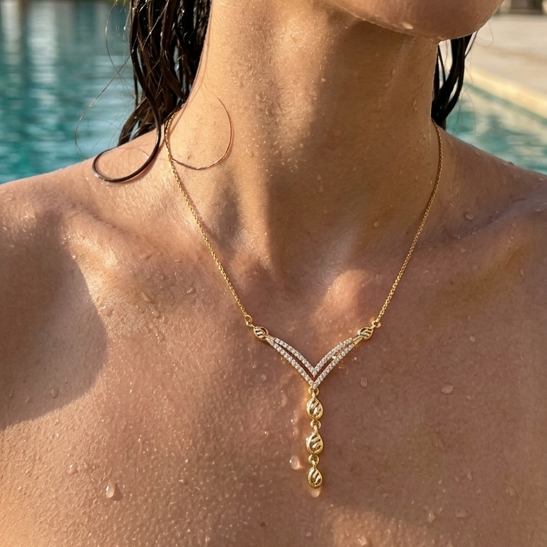 Woman wearing a gold necklace by a poolside