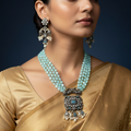 Antique silver-finish Kundan necklace set with aqua beads, worn on model with matching earrings