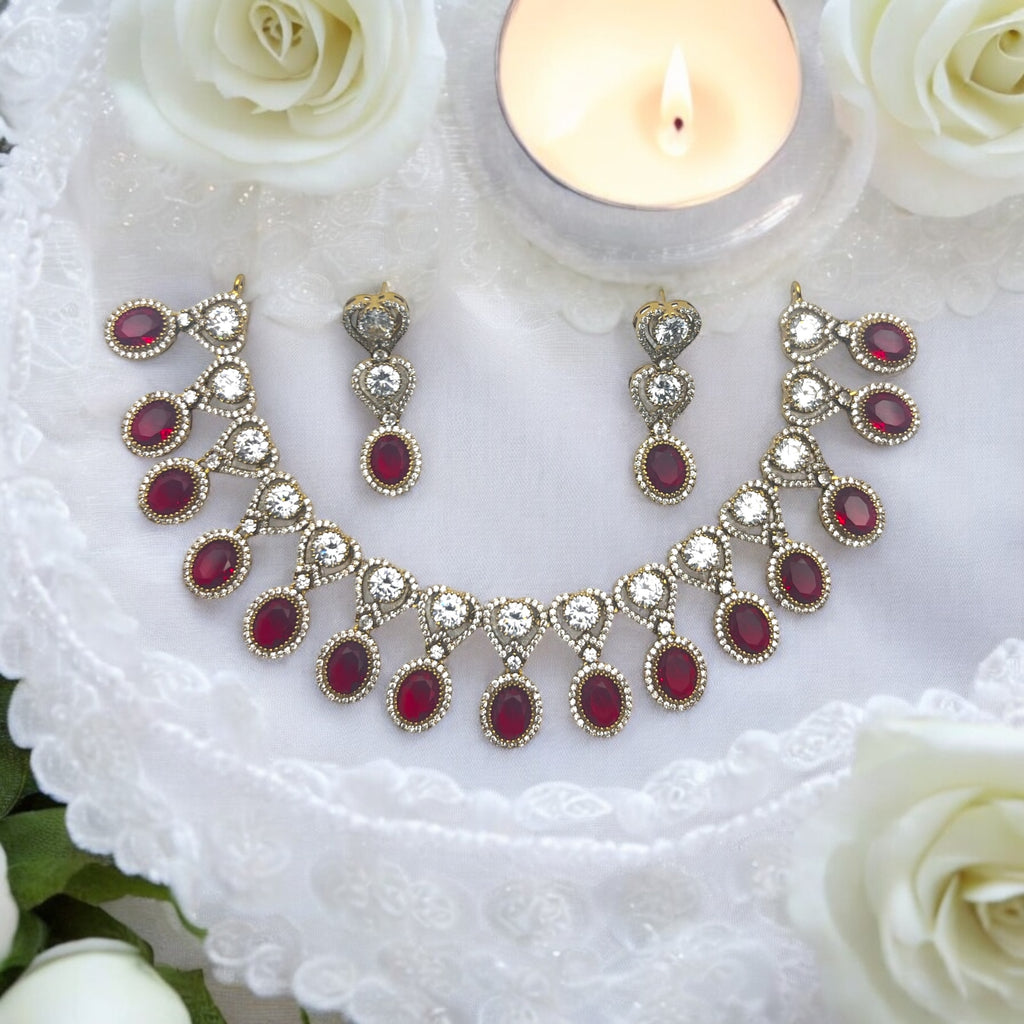 Gold-plated red and white stone necklace set with matching earrings, worn on model with saree