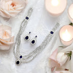Silver-tone sapphire-blue necklace set with triple-strand crystals and teardrop pendant, worn on model in gold saree