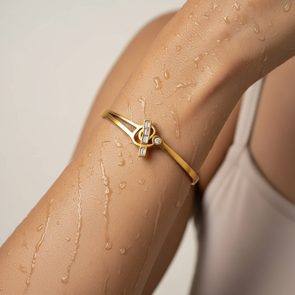 Gold bracelet on a person's wrist with a blurred background