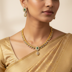 Antique gold-toned Pancharatna necklace set with white stone and green floral cluster design, worn on neck and ear close-up