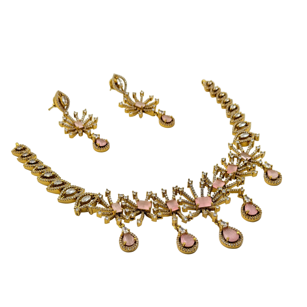 Gold necklace with pink stones on a white background