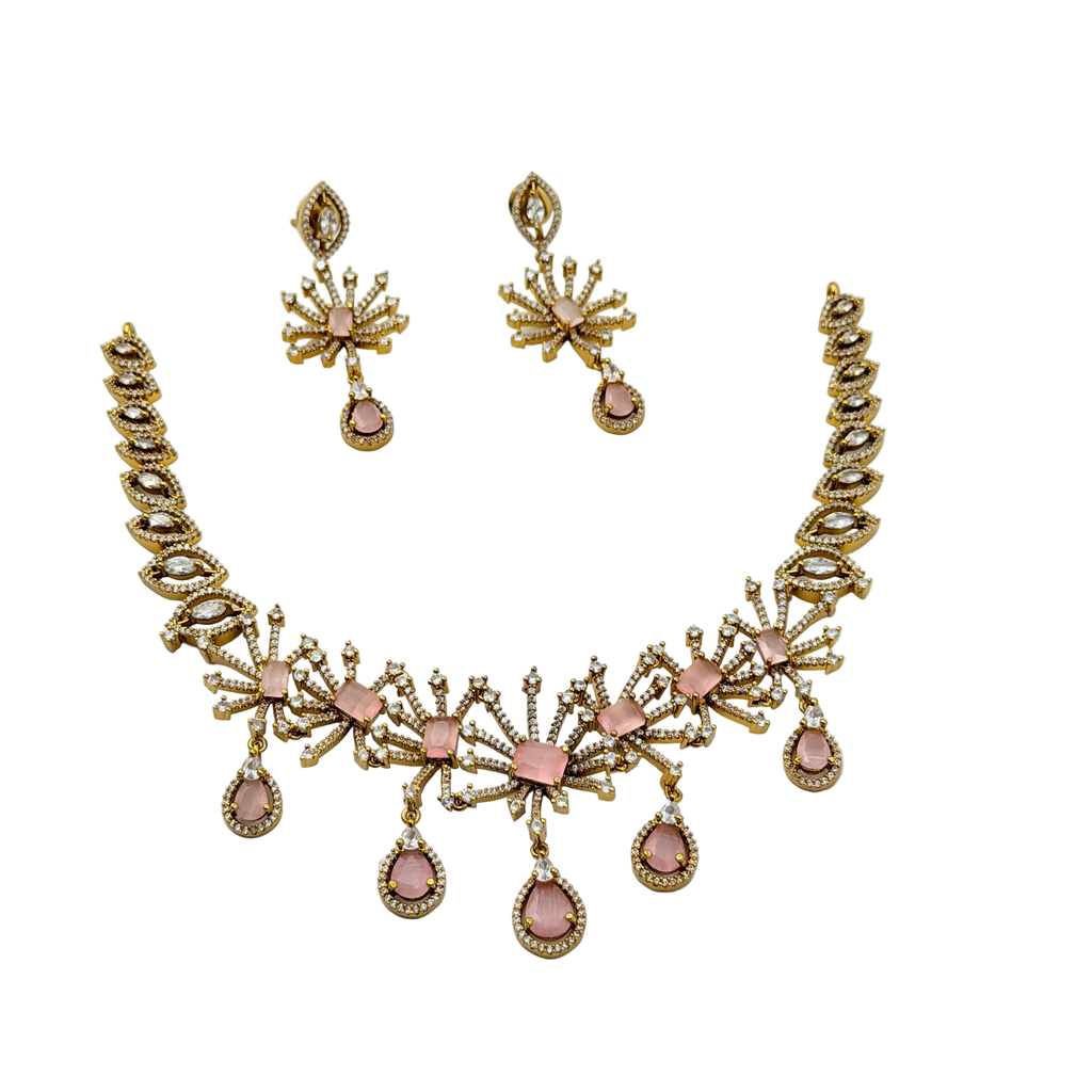 Gold and pink necklace set on a white background