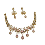 Gold and pink necklace set on a white background
