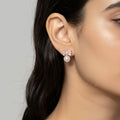 Bow-shaped earring with pearl center