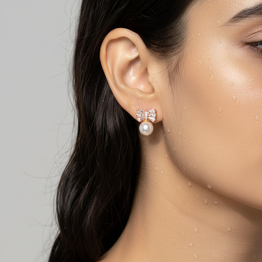 Bow-shaped earring with pearl center