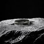 Bracelet with Roman numeral design on a textured surface