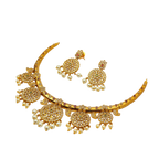 Gold necklace and earrings set on a white background
