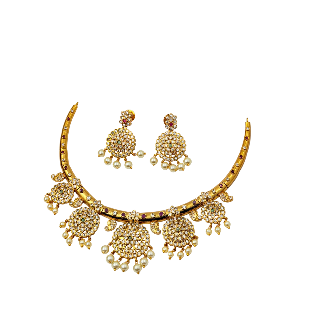 Gold necklace and earrings set on a white background