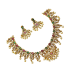 Gold necklace with gemstones and pearl accents on a white background