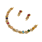 Gold necklace with colorful gemstones and matching earrings on a white background