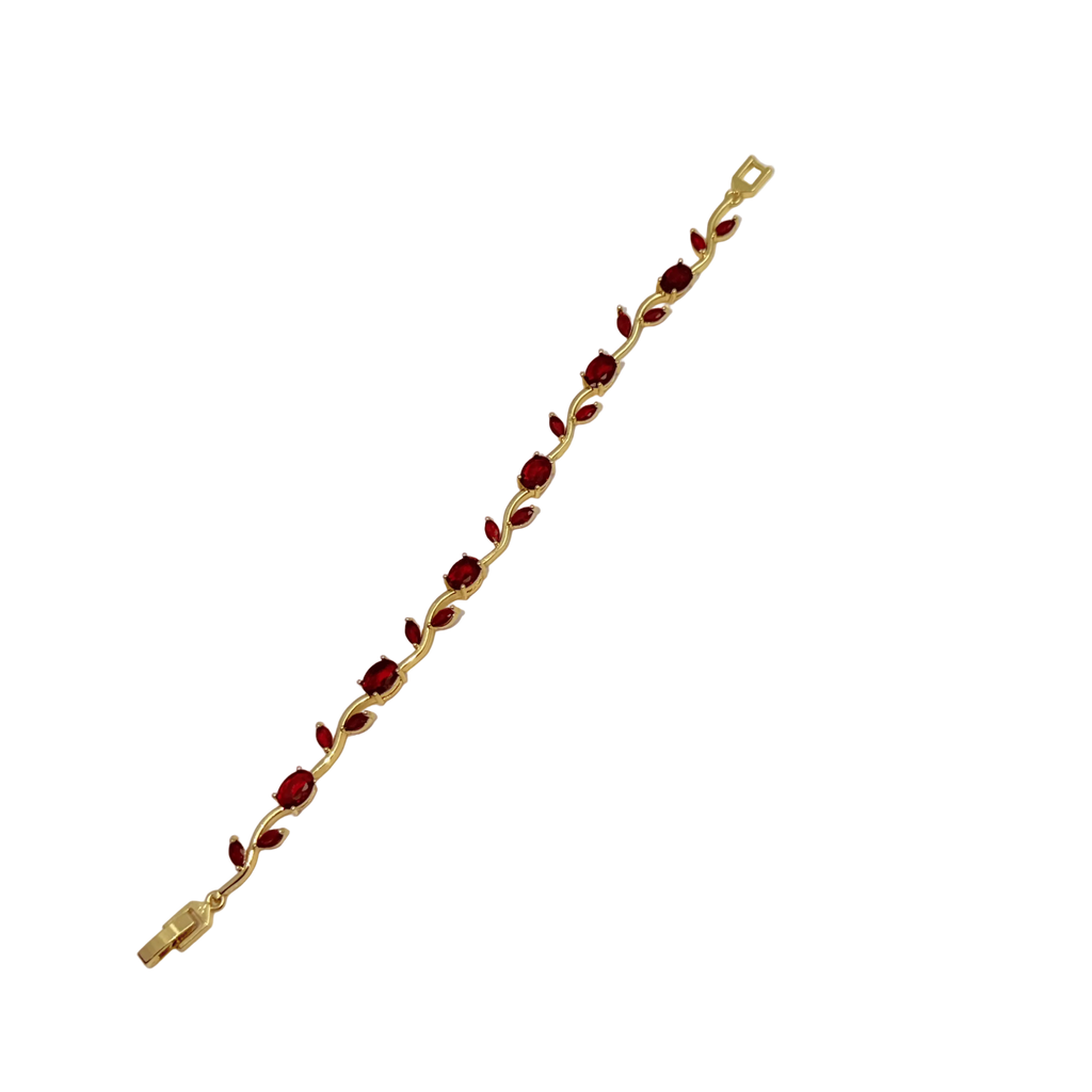 Gold bracelet with red stones on a white background
