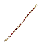 Gold bracelet with red stones on a white background