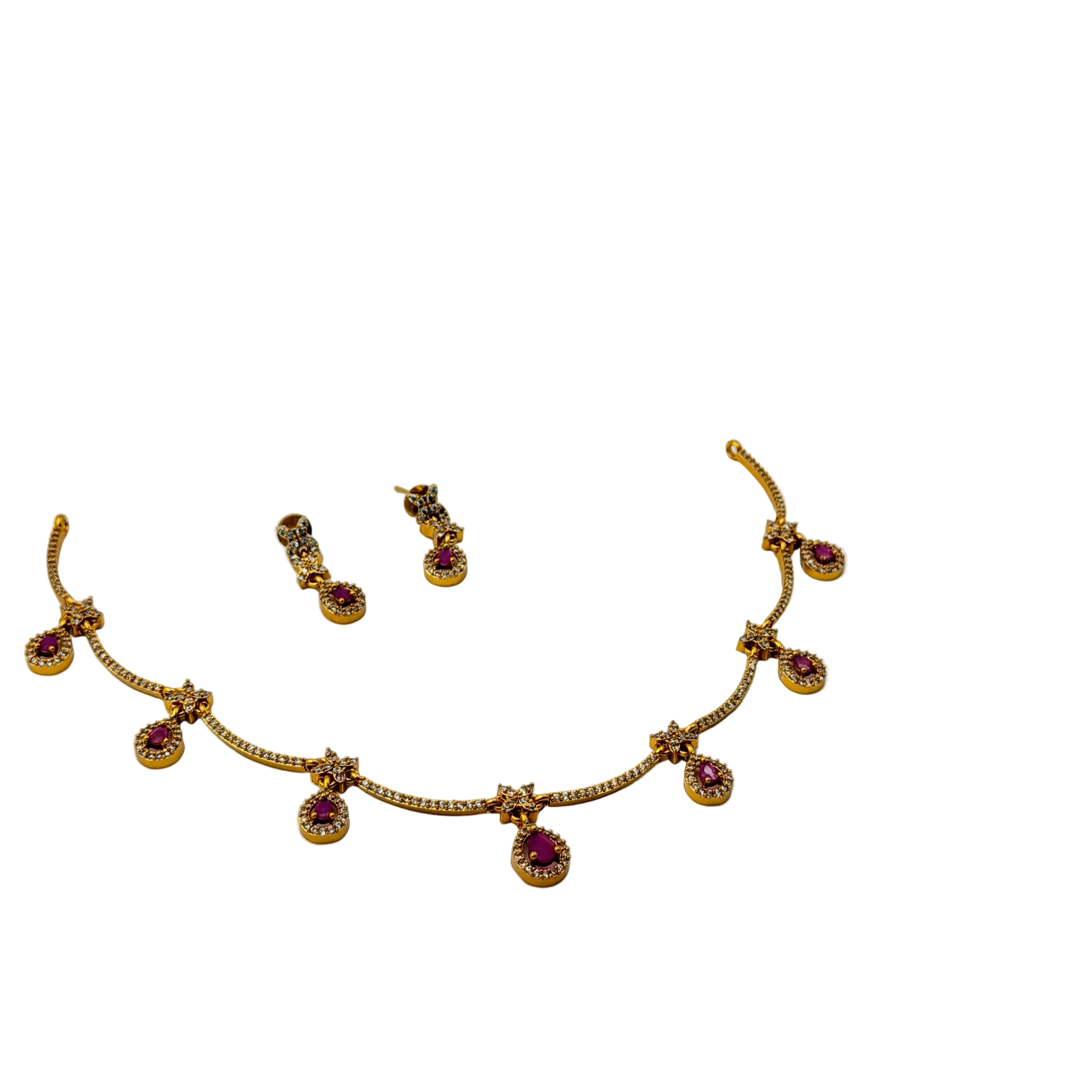 Gold necklace with red gemstones and matching earrings on a white background