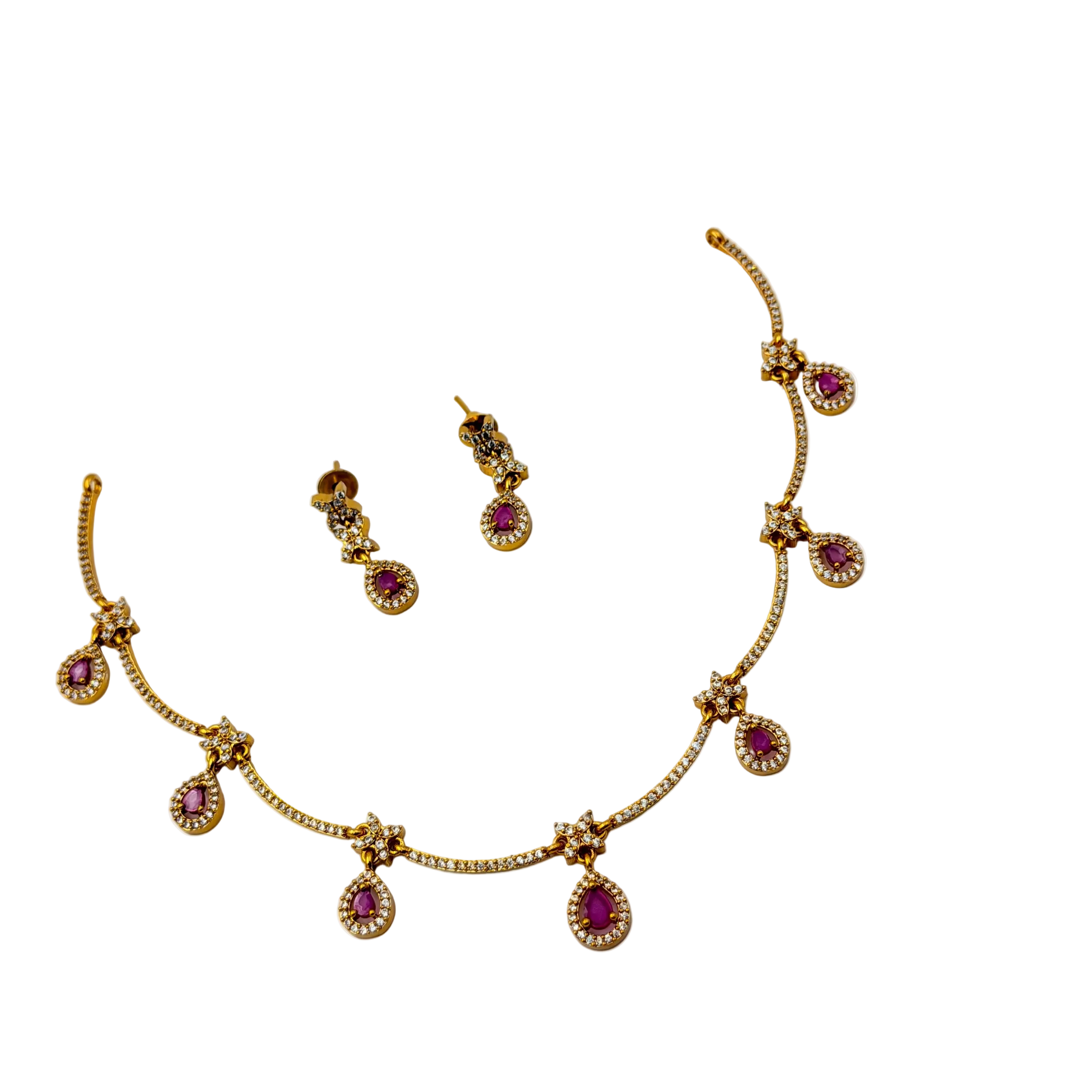 Gold necklace with red gemstones and matching earrings on a white background
