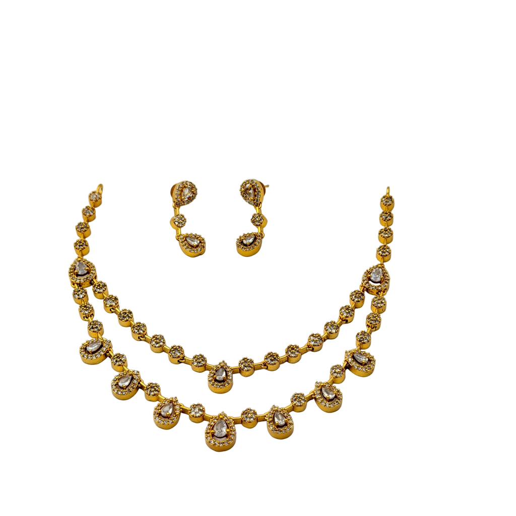 Gold necklace and earrings set on a white background