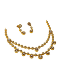 Gold necklace and earrings set on a white background