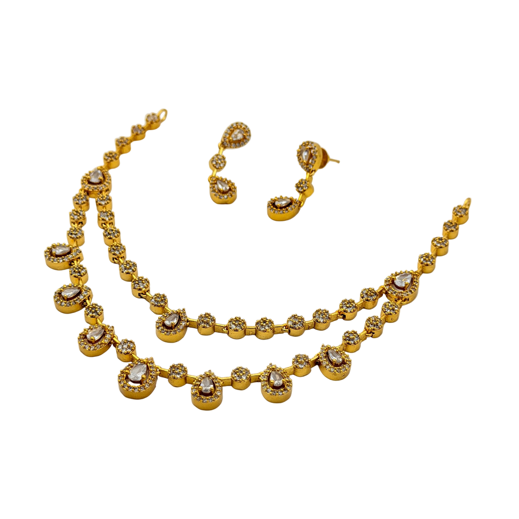 Gold necklace and earrings set on a white background