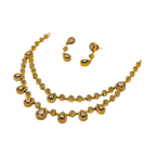 Gold necklace and earrings set on a white background