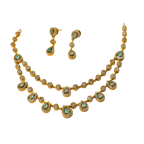 Gold necklace and earrings with turquoise stones on a white background
