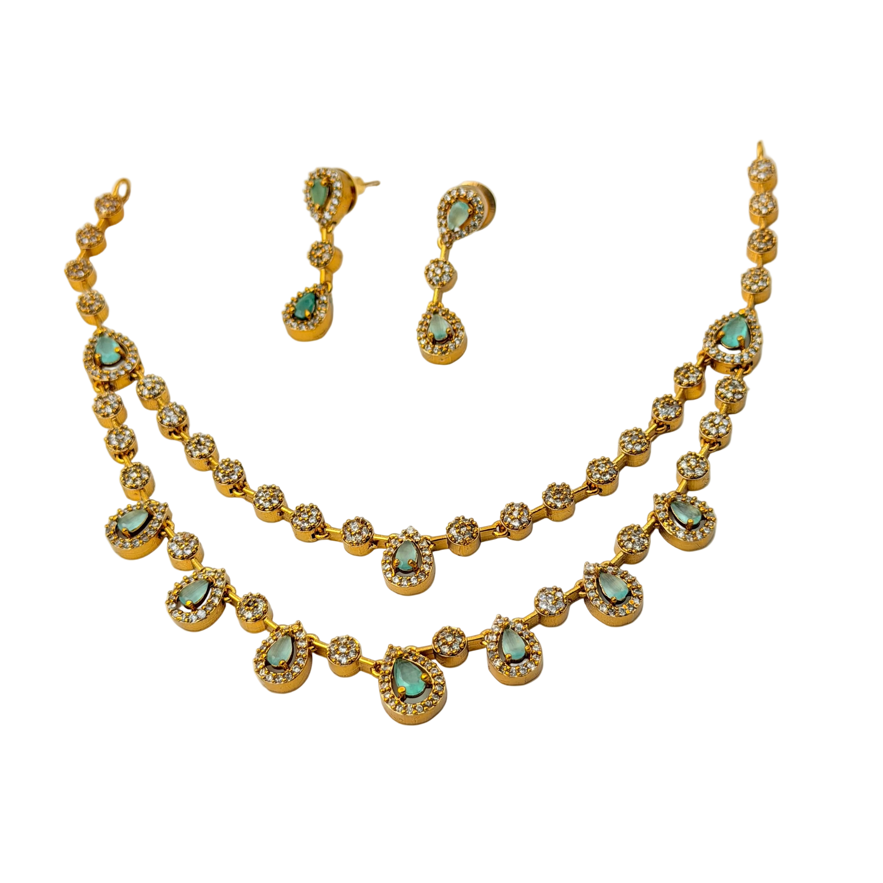 Gold necklace and earrings with turquoise stones on a white background