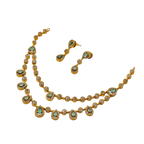 Gold necklace and earrings with turquoise stones on a white background