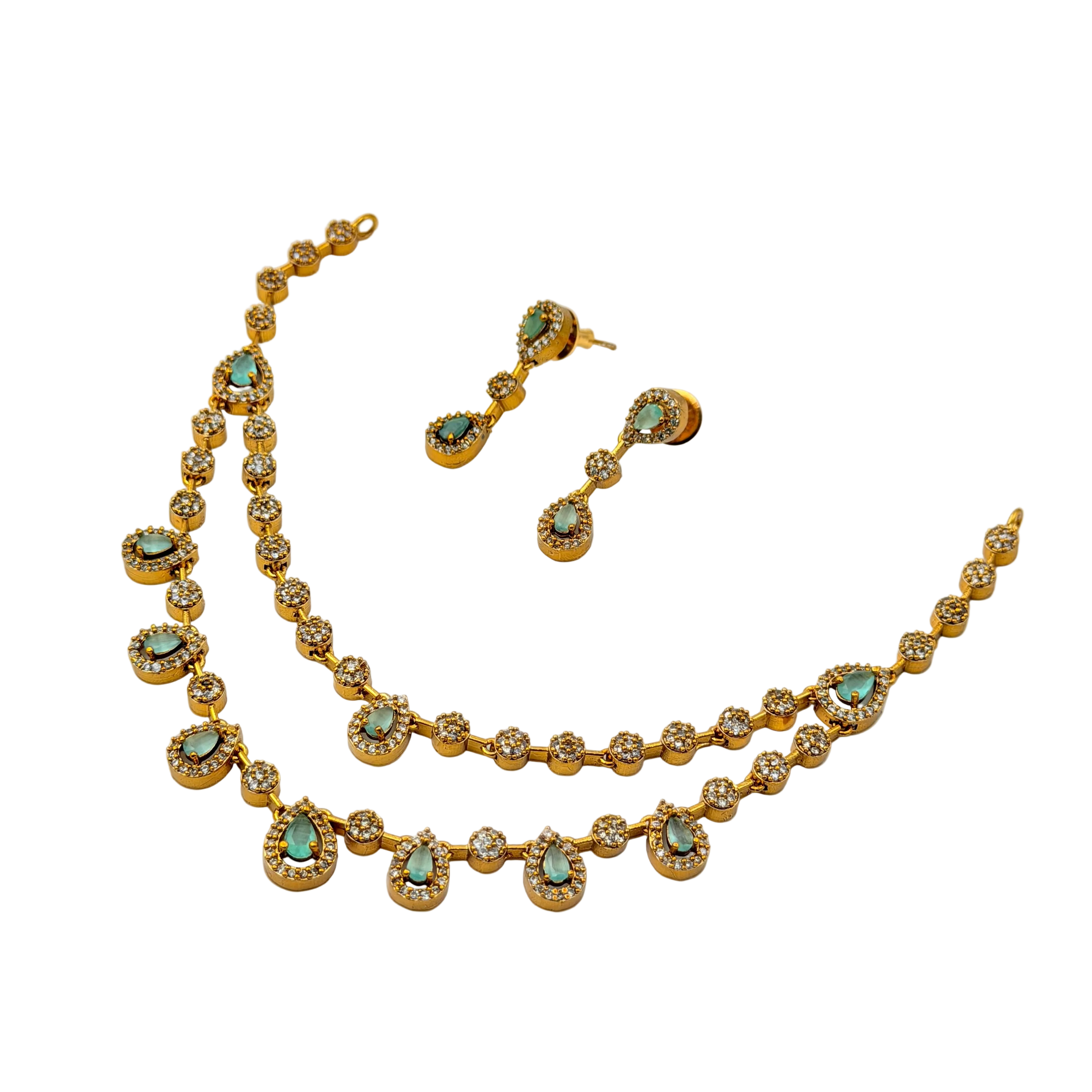 Gold necklace and earrings with turquoise stones on a white background