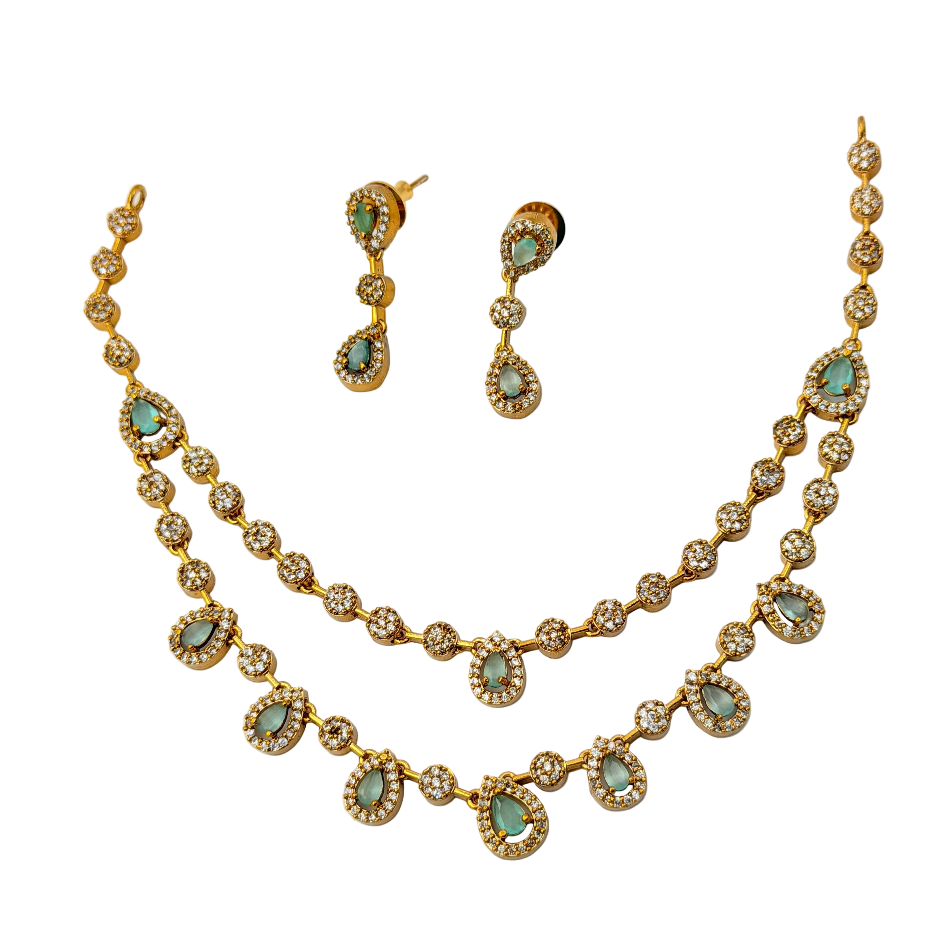 Gold necklace with green gemstones and matching earrings on a white background
