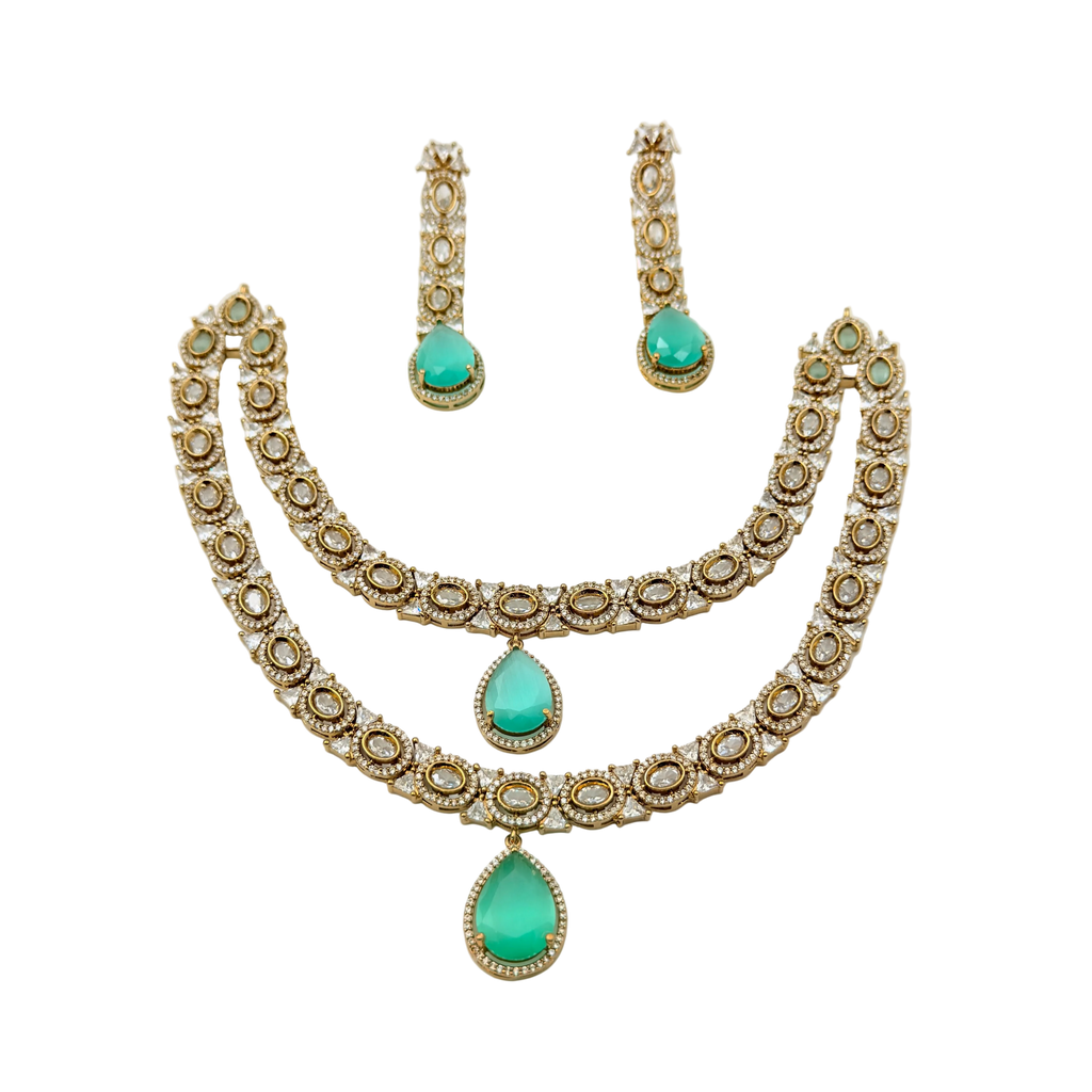 Jewelry set with necklace and earrings featuring turquoise stones on a white background