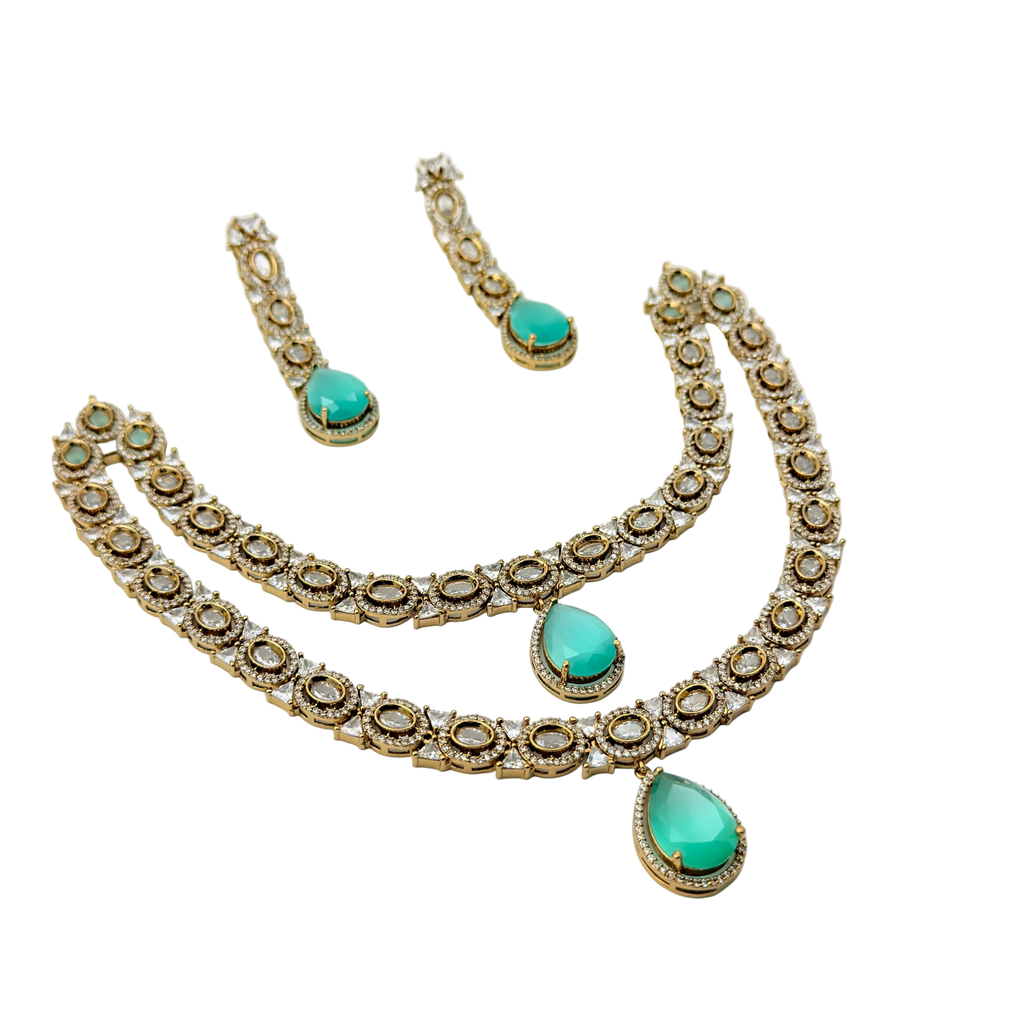 Jewelry set with necklace and earrings featuring turquoise stones on a white background