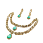 Gold necklace with green gemstones on a white background