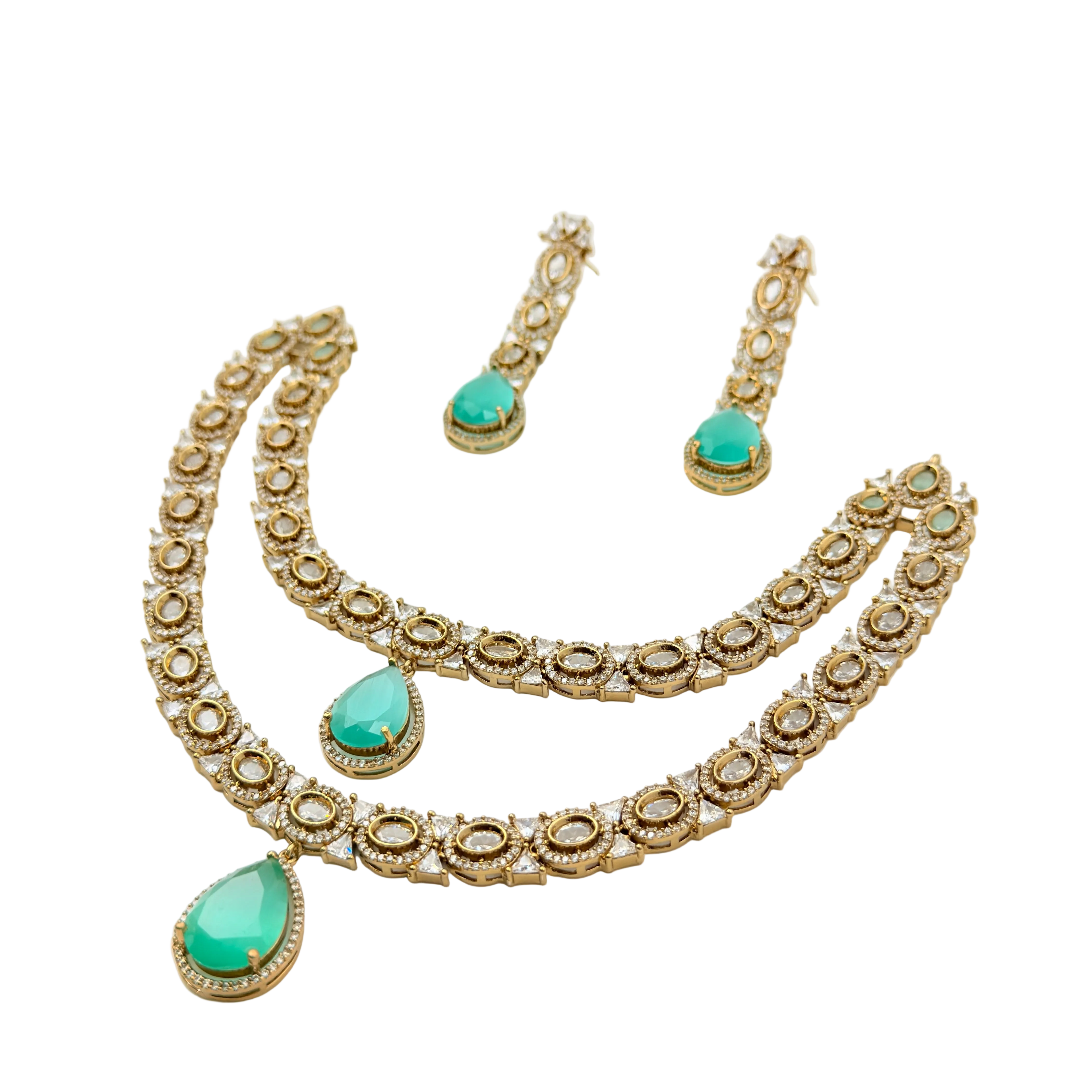 Gold necklace with green gemstones on a white background