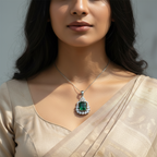 Silver-tone emerald-green halo pendant with CZ accents, worn on a model with a saree