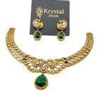 Gold necklace with green gemstones and matching earrings on a Krystal Jewels card.
