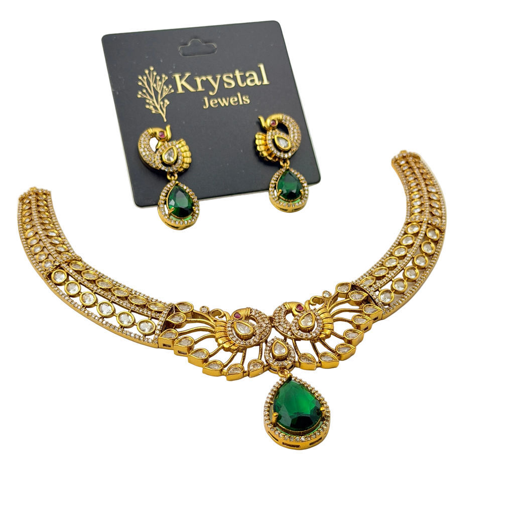 Gold necklace with green gemstones on a Krystal Jewels card