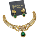 Gold necklace with green gemstones and matching earrings on a Krystal Jewels card.