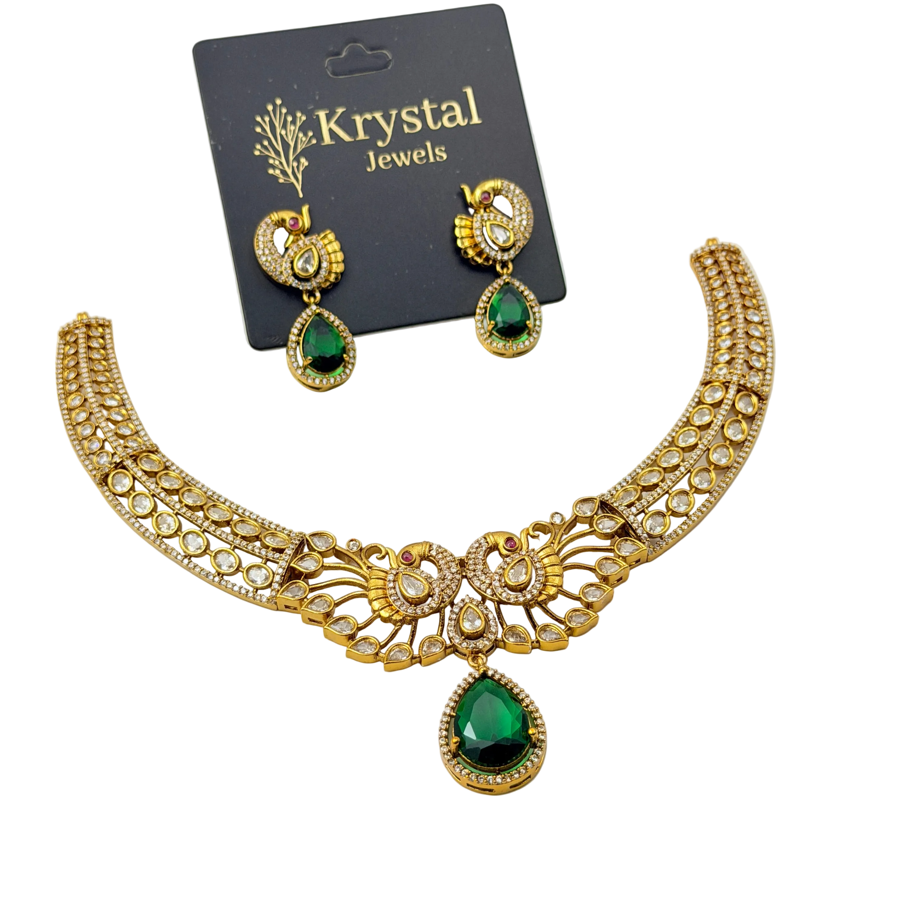 Gold necklace with green gemstones and matching earrings on a Krystal Jewels card.
