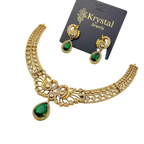 Gold necklace with green teardrop pendants and matching earrings on a Krystal Jewels card.