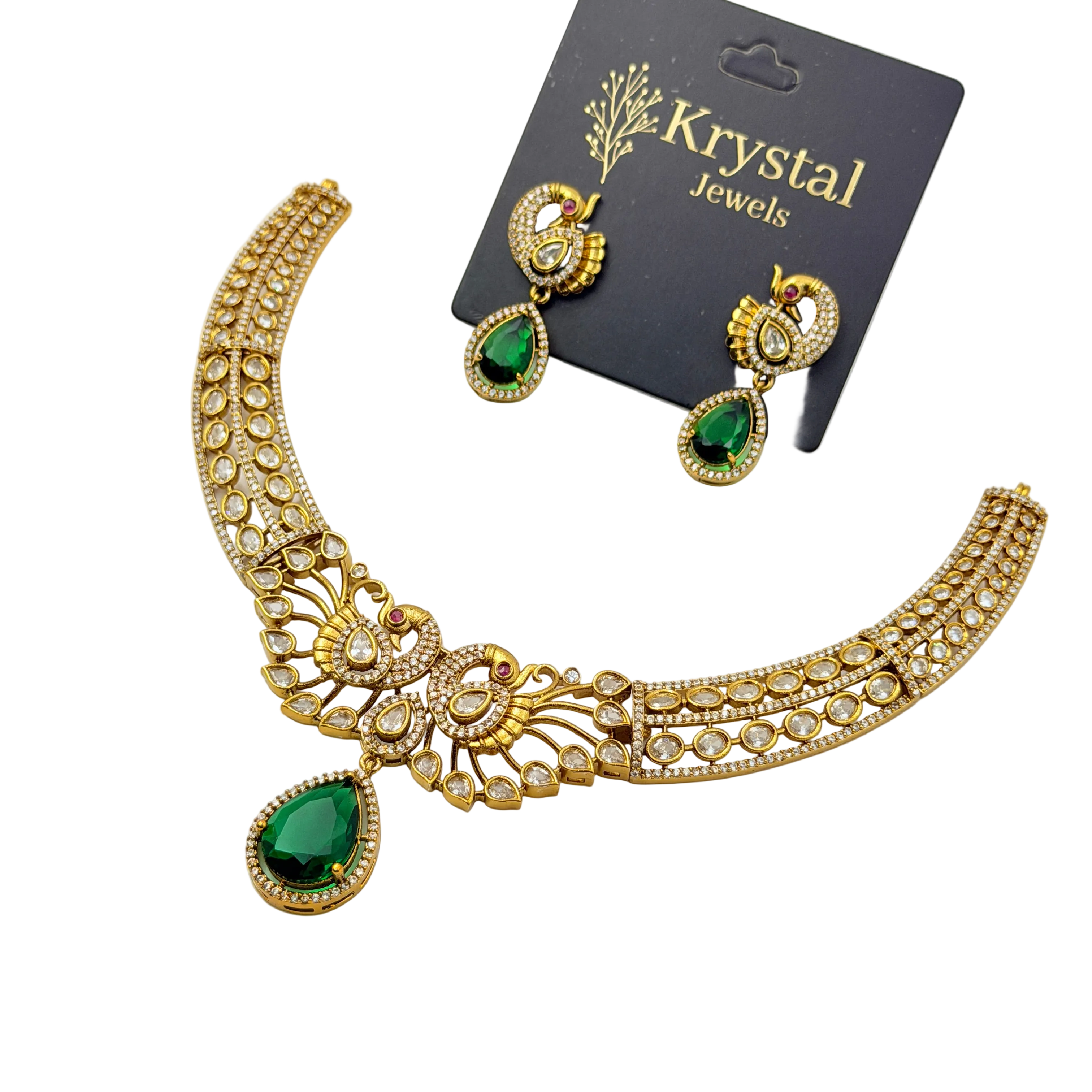 Gold necklace with green teardrop pendants and matching earrings on a Krystal Jewels card.