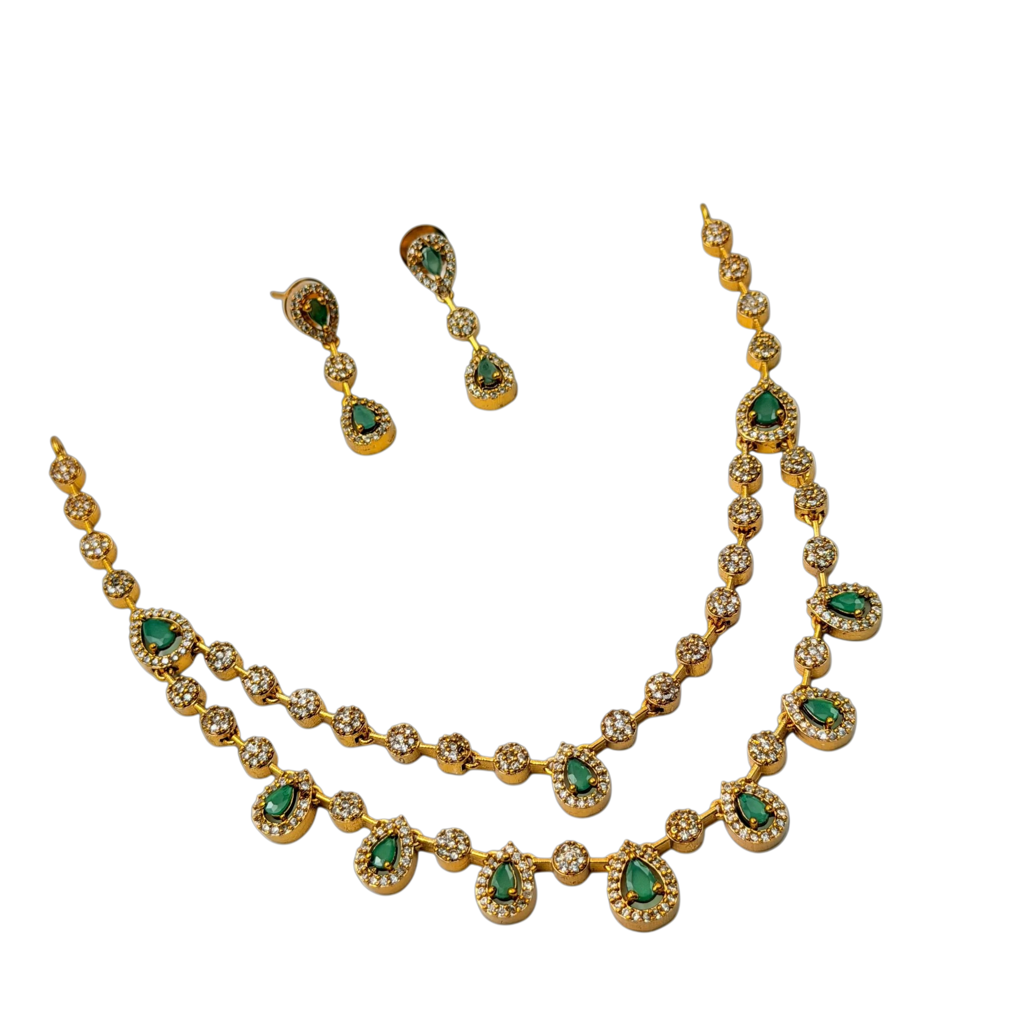 Gold necklace with green gemstones and matching earrings on a black background